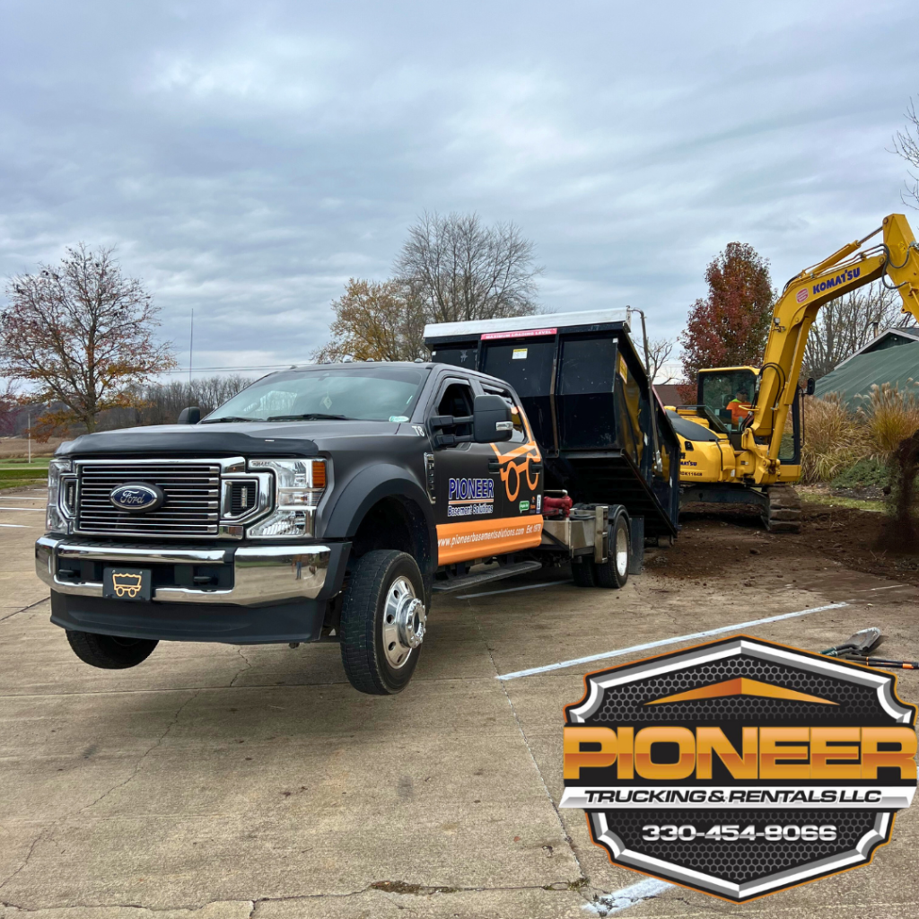 Pioneer Trucking & Rentals Dumpsters so heavy the truck is lifting off the ground.